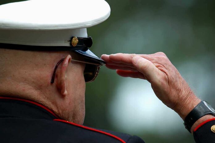 An,Old,Marine,Saluting A veteran in military uniform saluting with a hand raised