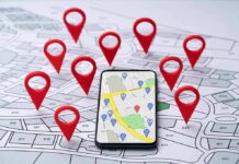 Smartphone with map app surrounded by red location pins