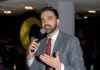 Zohran Mamdani speaking into a microphone
