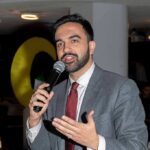 Zohran Mamdani speaking into a microphone
