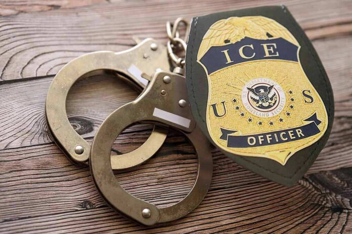 Kyiv,,Ukraine,-,September,17,,2025,Us,Ice,Officer,Badge ICE officer badge and handcuffs on wooden surface