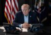 Trump Demands Americans To PAY High Gas Prices Person in suit seated at table with telephones