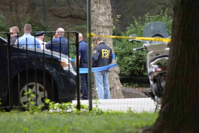 law enforcement officers gather at taped-off outdoor scene
