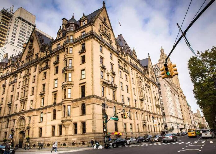 shutterstock_780288265 Historic stone apartment building on a busy city corner