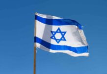Israel SoccerHandshake Snub Ignites Fiery Standoff Israeli flag waving against a clear blue sky
