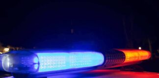Police car light bar flashing blue and red at night