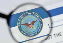 magnifying glass focusing on U.S. Department of Defense seal