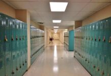 Teacher Pleads GUILTY After Damning Leaked Texts School hallway with rows of teal lockers