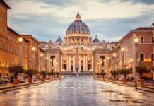 Popes Cancer Diagnosis STUNS – Vatican Statement St. Peter's Basilica at the end of a wet street at dusk