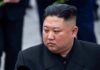 Kim Jong-Un looking to the side in a dark overcoat