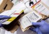 Meghan Markle’s Father Found With Huge Child Sex Abuse Stash Gloved hands handling labeled evidence bags and boxes