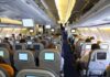Water Pours From Ceiling Mid-Flight – Passengers PANIC Interior view of an airplane with passengers seated and using in-flight entertainment screens