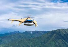 First Drone Battlefield Airlift Stuns War Watchers Cargo drone helicopter flying over green mountain range