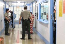 Death Row Twist: Inmate Demands Execution Corrections officers escort an inmate in a jail hallway
