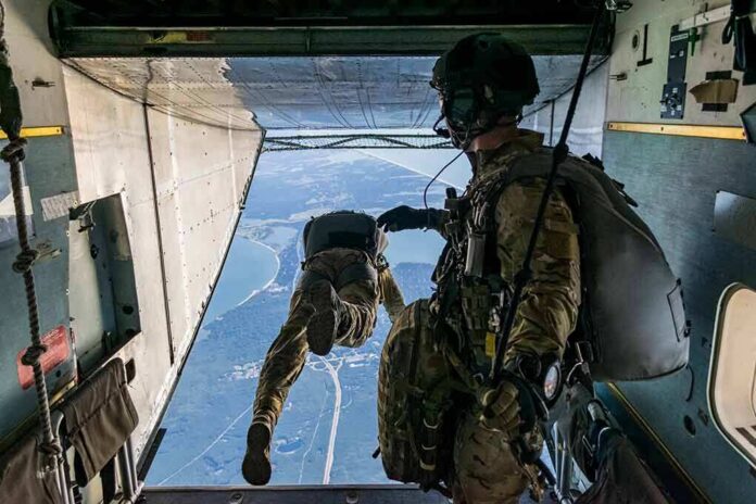 shutterstock_1679401603 Paratroopers jump from a military aircraft over coastline
