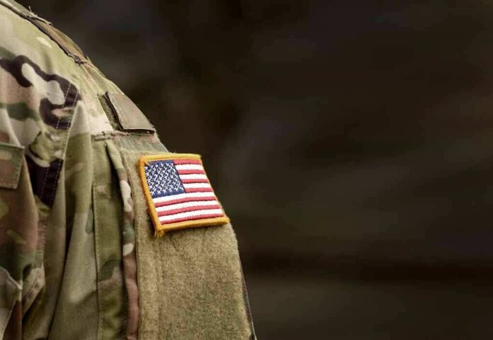 shutterstock_1711682218 american flag patch on camouflage uniform sleeve