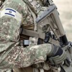 soldier in camouflage holding a rifle
