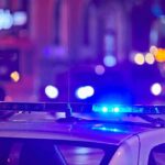 police car roof with flashing blue lights at night