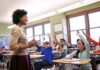 OnlyFans Uproar Boots Teacher – Then BOOM Teacher engaging students in a classroom
