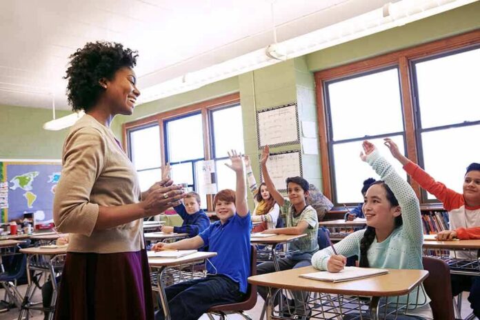 shutterstock_2250724177 Teacher engaging students in a classroom