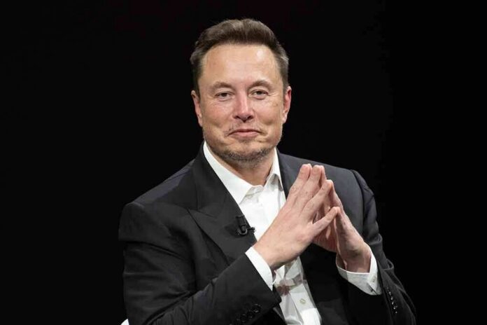 shutterstock_2318800323 Elon Musk seated in a black suit with hands clasped