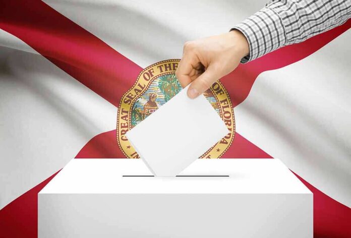 Hand casting a ballot in front of the Florida state flag