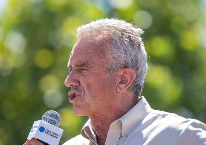 shutterstock_2346739541 Robert F. Kennedy Jr. speaking into a microphone outdoors