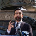 Zohran Mamdani speaking at an outdoor press conference