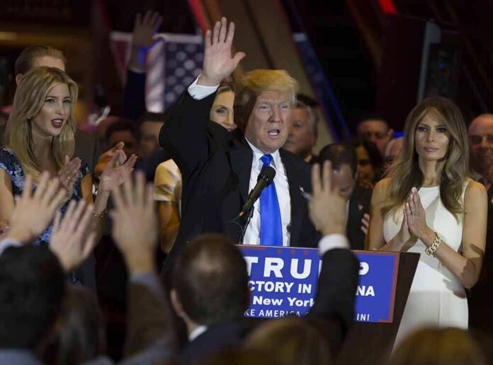 shutterstock_415321102 Donald Trump speaks at a rally with Ivanka Trump and Melania Trump on stage; Karlie Kloss in the crowd
