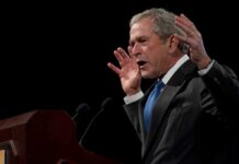 Bush Family Member Betrays GOP – Does The Worst! George W. Bush speaking at a podium with hands raised